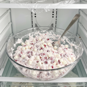 Cranberry marshmallow fluff salad chilling in the fridge before serving.