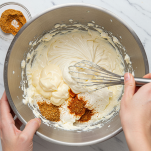 Mixing creamy base for crab and spinach dip