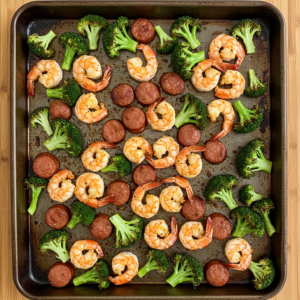 Roasted shrimp, sausage, and broccoli on a sheet pan.